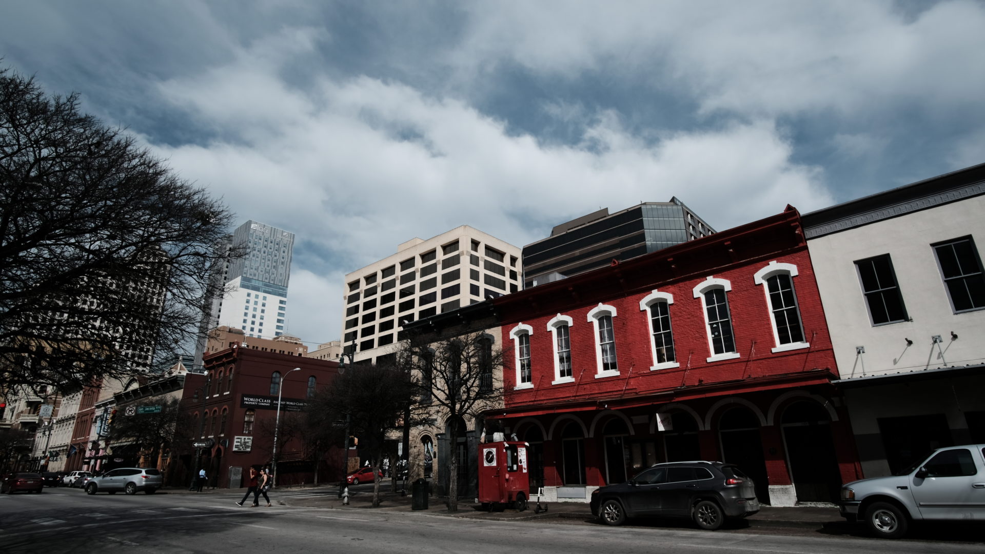 A scene of downtown Austin, with an older building painted in red