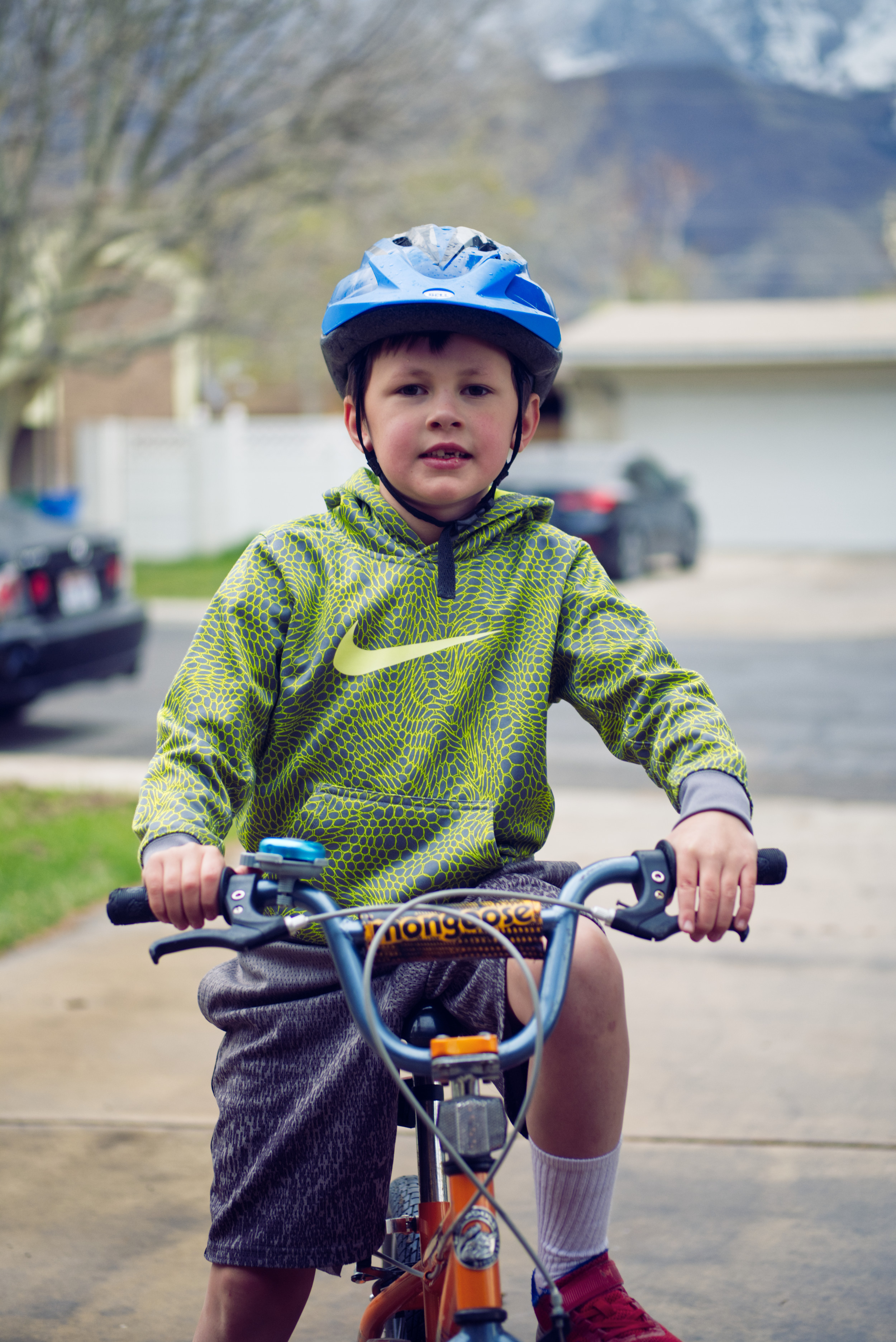 Emmett poses on his orange bike.